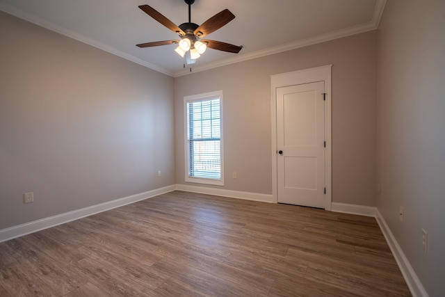 unfurnished room with hardwood / wood-style flooring, ceiling fan, and ornamental molding