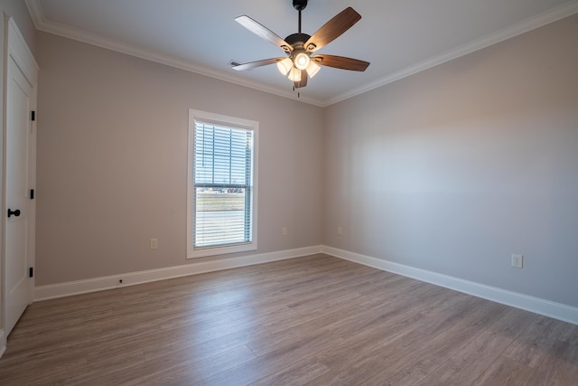 empty room featuring ornamental molding, hardwood / wood-style floors, and ceiling fan