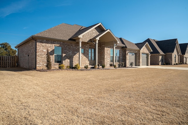 craftsman-style home with a front lawn and a garage