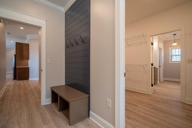 mudroom featuring light hardwood / wood-style flooring and crown molding