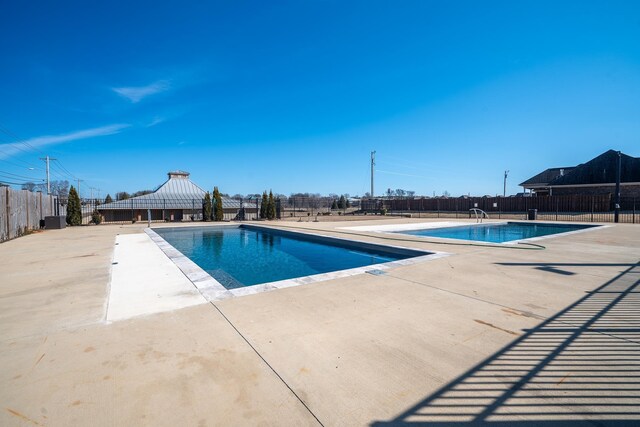 view of swimming pool with a patio and a gazebo