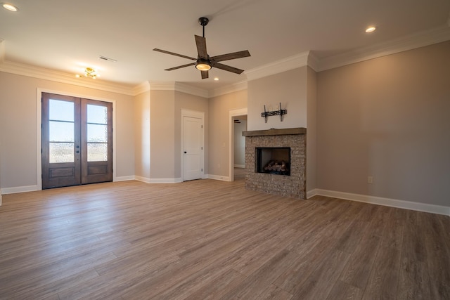 unfurnished living room featuring french doors, crown molding, ceiling fan, and wood-type flooring