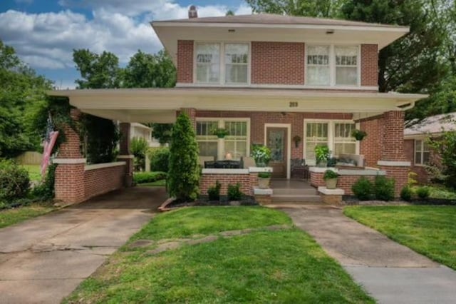 - traditional style home featuring brick siding, concrete driveway, and a front yard