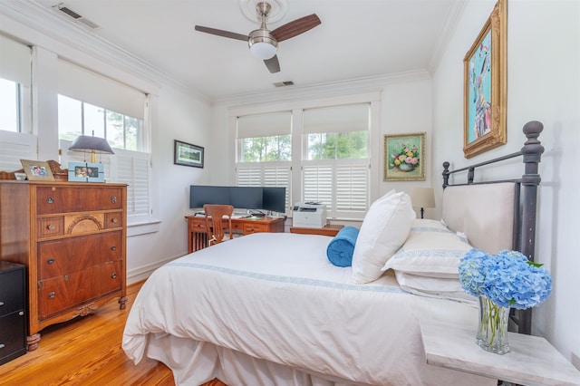  - bedroom featuring multiple windows, light wood-type flooring, and crown molding