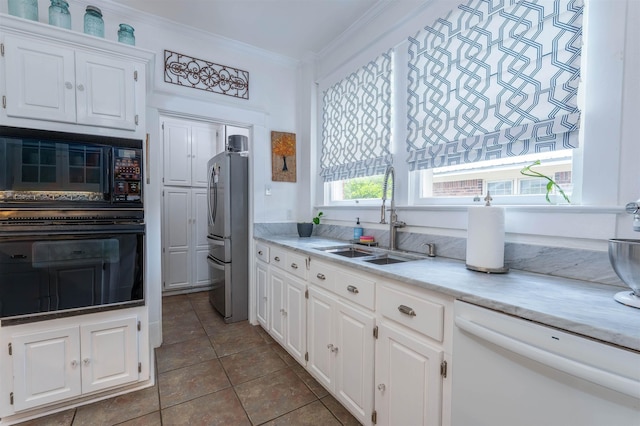  - kitchen featuring black appliances, a sink, ornamental molding, white cabinets, and tile patterned floors