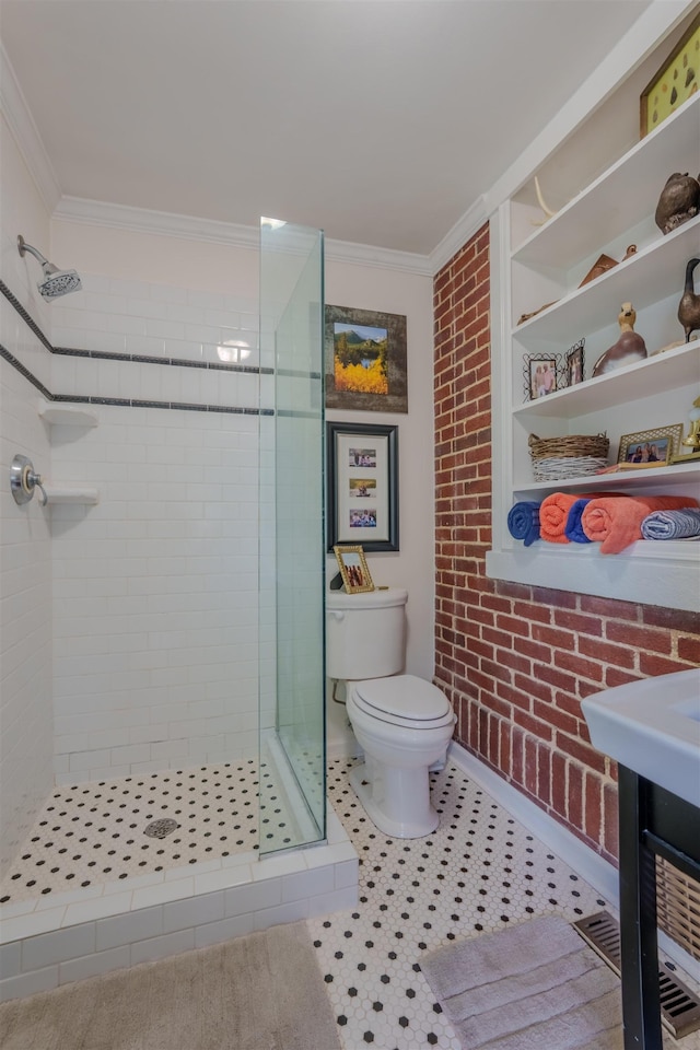  - bathroom with crown molding, a stall shower, toilet, and baseboards
