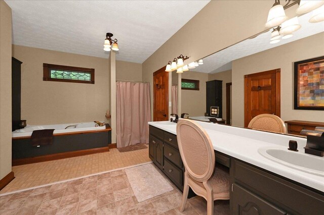  - bathroom featuring vanity, a garden tub, and a shower with shower curtain