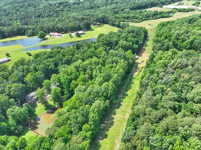  - aerial view of property's location with a large body of water and a heavily wooded area