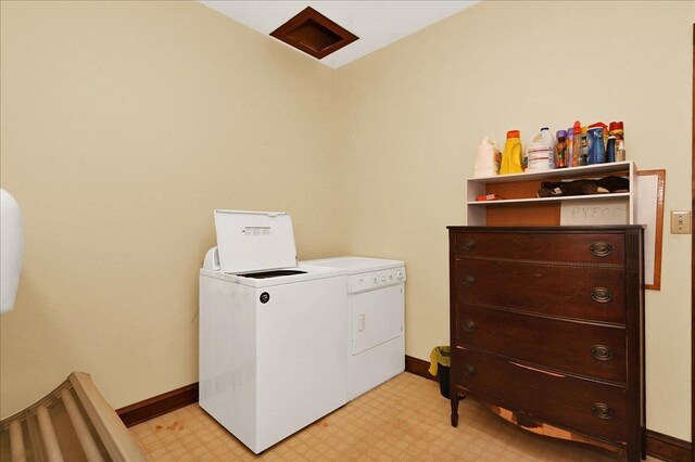  - laundry area with washer and clothes dryer, light flooring, and baseboards