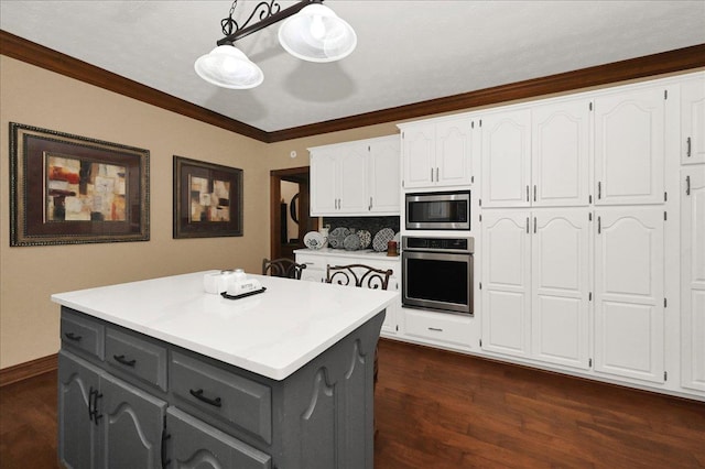  - kitchen featuring stainless steel appliances, gray cabinets, white cabinets, dark wood-type flooring, and crown molding