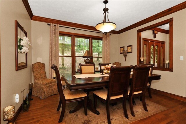  - dining area featuring crown molding, wood finished floors, and baseboards