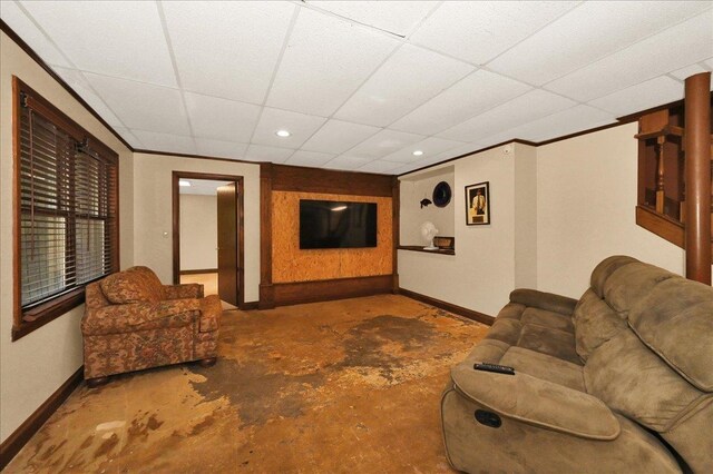  - living room with baseboards, a drop ceiling, unfinished concrete flooring, and recessed lighting