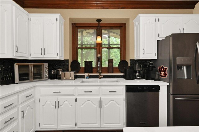  - kitchen with appliances with stainless steel finishes, a sink, white cabinets, and decorative backsplash