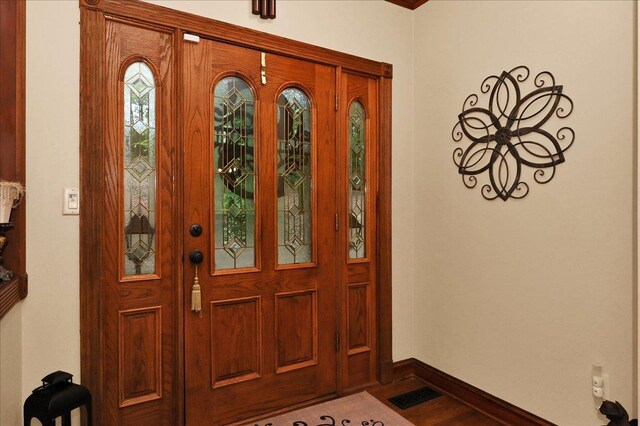  - entryway featuring baseboards and wood finished floors