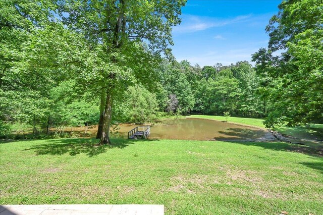  - view of green lawn with a wooded view