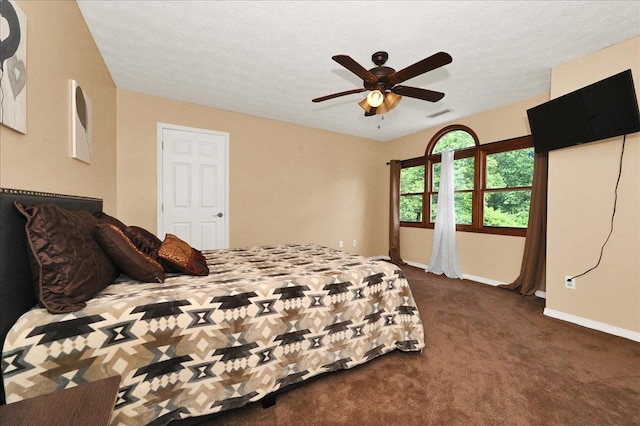  - bedroom with dark carpet, baseboards, and ceiling fan