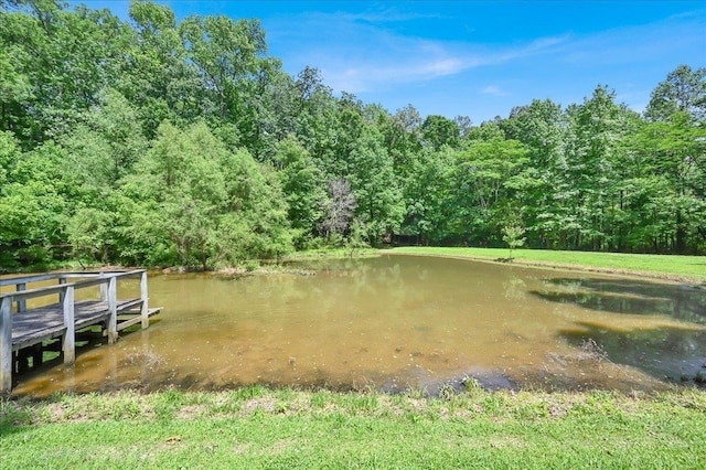  - dock area featuring a water view and a forest view