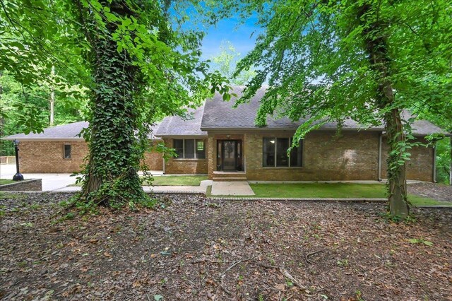  - view of front of home featuring roof with shingles and brick siding