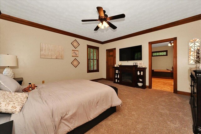  - carpeted bedroom featuring baseboards, crown molding, ensuite bath, ceiling fan, and a fireplace