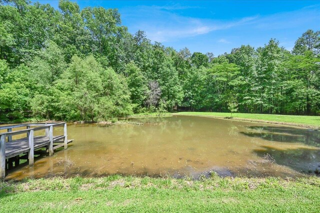  - dock featuring a forest view and a water view