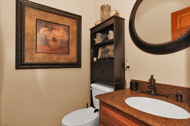  - half bathroom featuring toilet and vanity