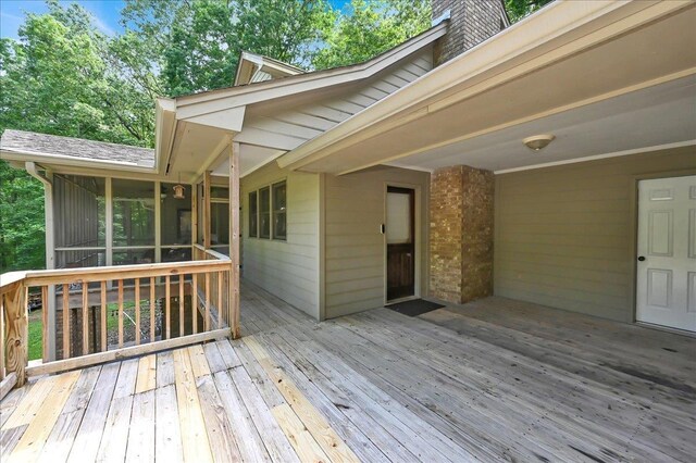  - wooden terrace featuring a sunroom