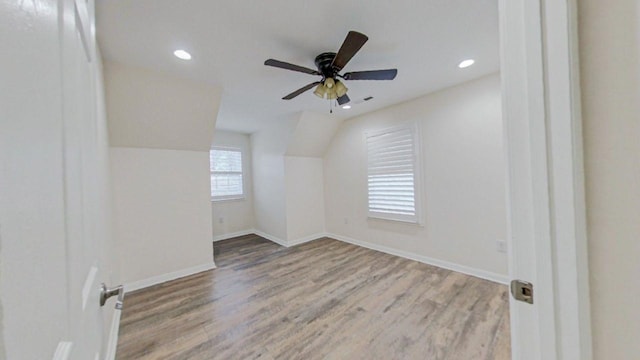 bonus room with lofted ceiling, light hardwood / wood-style floors, and ceiling fan