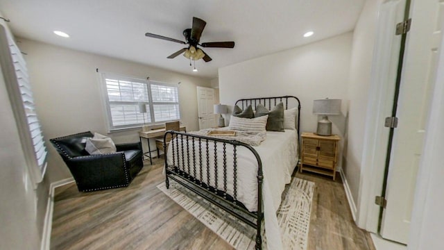 bedroom featuring hardwood / wood-style flooring and ceiling fan