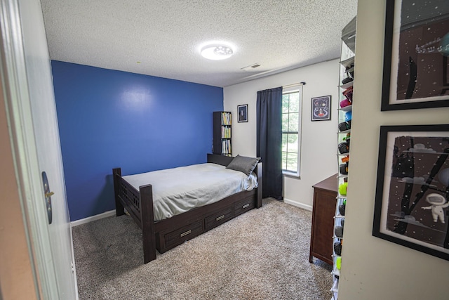  - bedroom with carpet flooring, baseboards, and a textured ceiling