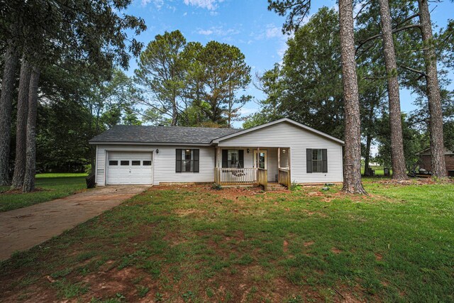 - view of front of house with a porch, a garage, concrete driveway, and a front yard