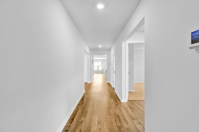  - hallway featuring light wood-style floors, baseboards, and recessed lighting