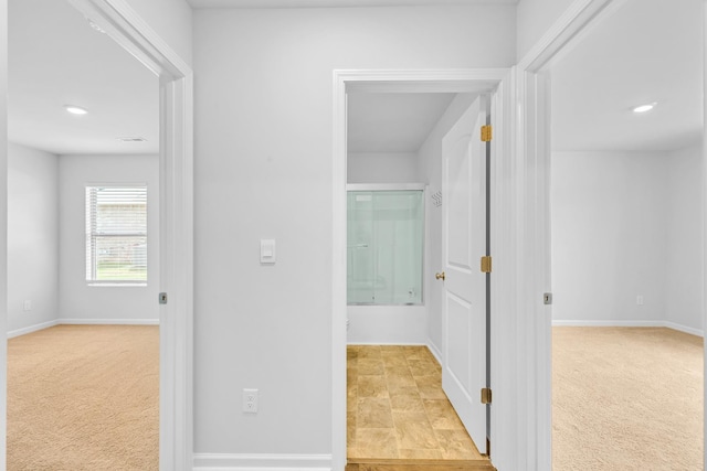  - hallway featuring light carpet, baseboards, and recessed lighting