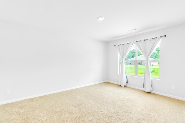  - empty room with baseboards and carpet flooring
