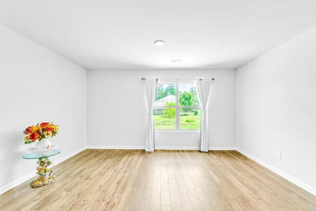  - spare room featuring wood finished floors and baseboards