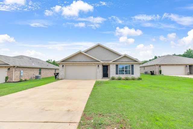  - view of front of house with central AC, brick siding, a front lawn, an attached garage, and driveway