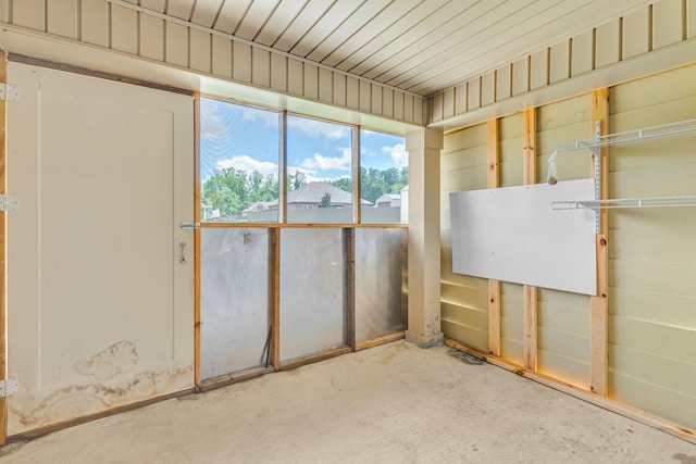  - miscellaneous room featuring unfinished concrete flooring