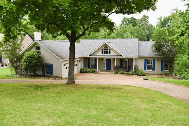  - view of front of property with asphalt driveway, a garage, covered porch, and a front lawn