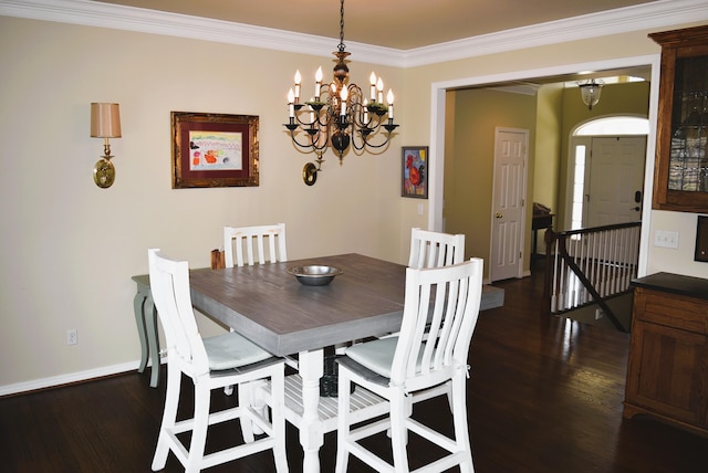  - dining area with dark wood finished floors, ornamental molding, baseboards, and a chandelier