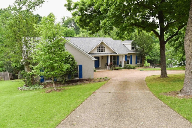  - view of front of property featuring concrete driveway, a front yard, and brick siding