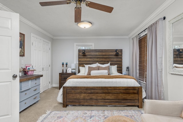 bedroom featuring ceiling fan, crown molding, light carpet, and a closet