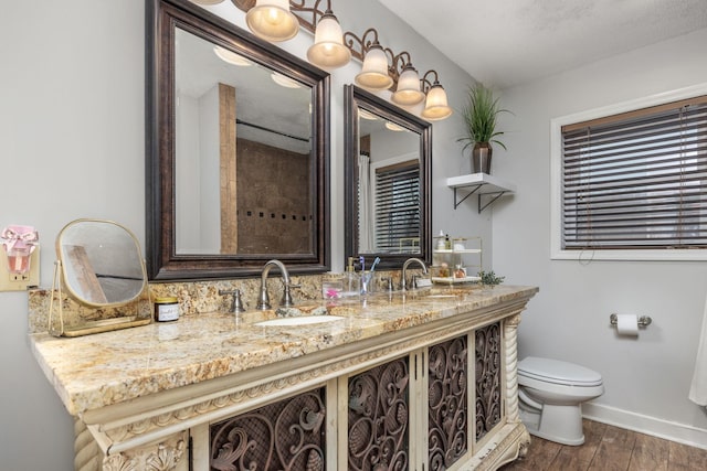 bathroom with vanity, a textured ceiling, and toilet