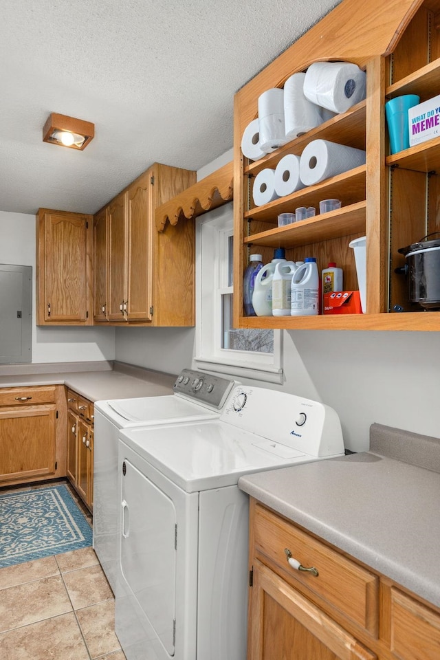 laundry room with cabinets, independent washer and dryer, electric panel, a textured ceiling, and light tile patterned floors