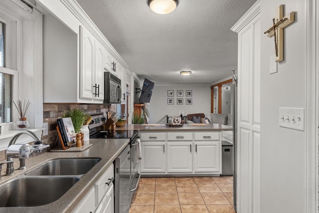 kitchen with white cabinetry, sink, light tile patterned floors, and appliances with stainless steel finishes