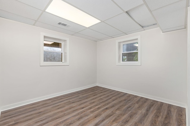 interior space featuring dark hardwood / wood-style flooring and a paneled ceiling