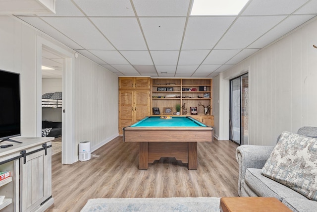 playroom featuring built in shelves, light wood-type flooring, a drop ceiling, and billiards