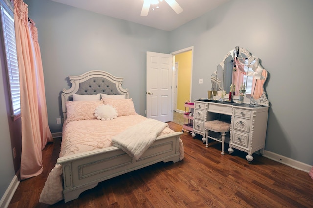 bedroom with ceiling fan, dark hardwood / wood-style floors, and multiple windows