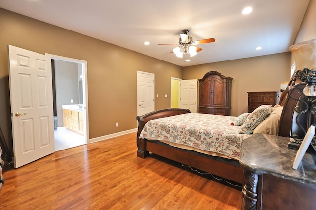 bedroom featuring ceiling fan, connected bathroom, and hardwood / wood-style floors