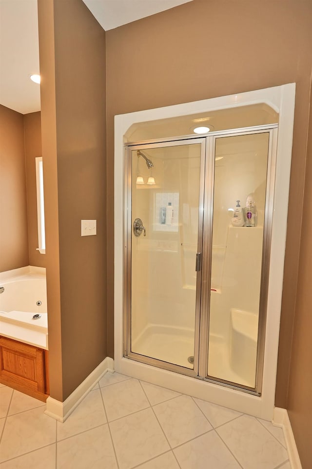 bathroom featuring tile patterned flooring and independent shower and bath