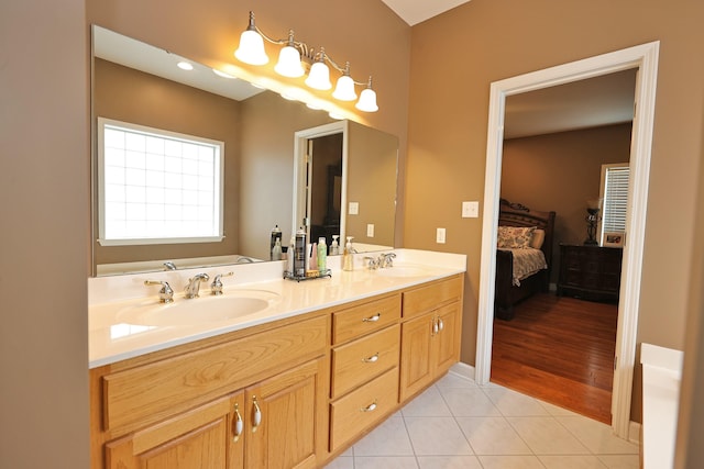 bathroom featuring vanity, a bathtub, and tile patterned floors