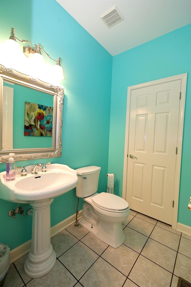 bathroom featuring tile patterned flooring and toilet